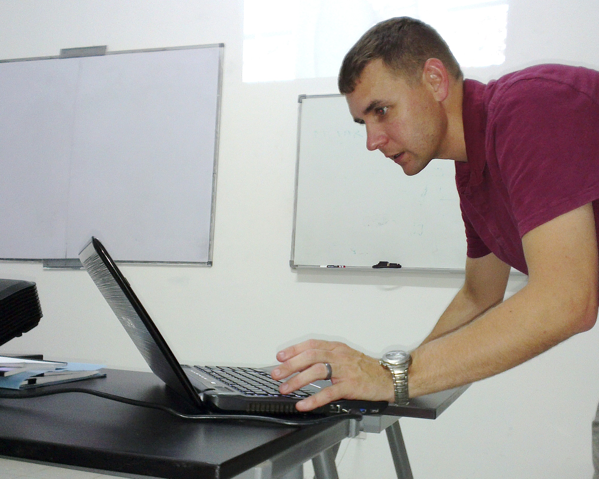 U.S. Air Force Maj. Steve Payne, Intelligence, Surveillance, Reconnaissance mission planning instructor from U.S. Air Forces in Europe and Air Forces Africa, tests his laptop for operations in Atar, Mauritania prior to starting a class where airmen from six African nations will learn about ISR mission planning during African Partnership Flight, Aug. 30, 2014. APF is the premier program for building aviation capacity, enhancing regional cooperation, and increasing U.S. and African interoperability. (U.S. Air Force photo/Master Sgt. Brian Boisvert/Released)