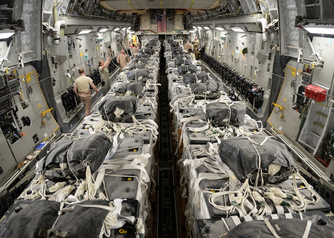 U.S. Army 11th Quartermaster Company parachute riggers assemble 40 container delivery system bundles of water onto a C-17 Globemaster III for a humanitarian airdrop over the area of Amirli, Iraq Aug. 30, 2014. Two C-17s dropped 79 bundles of fresh drinking water totaling 7,513 gallons. In addition, two C-130 Hercules dropped 30 bundles containing 3,032 gallons of water and 7,056 Halal Meals Ready to Eat. (U.S. Air Force photo by Staff Sgt. Shawn Nickel)