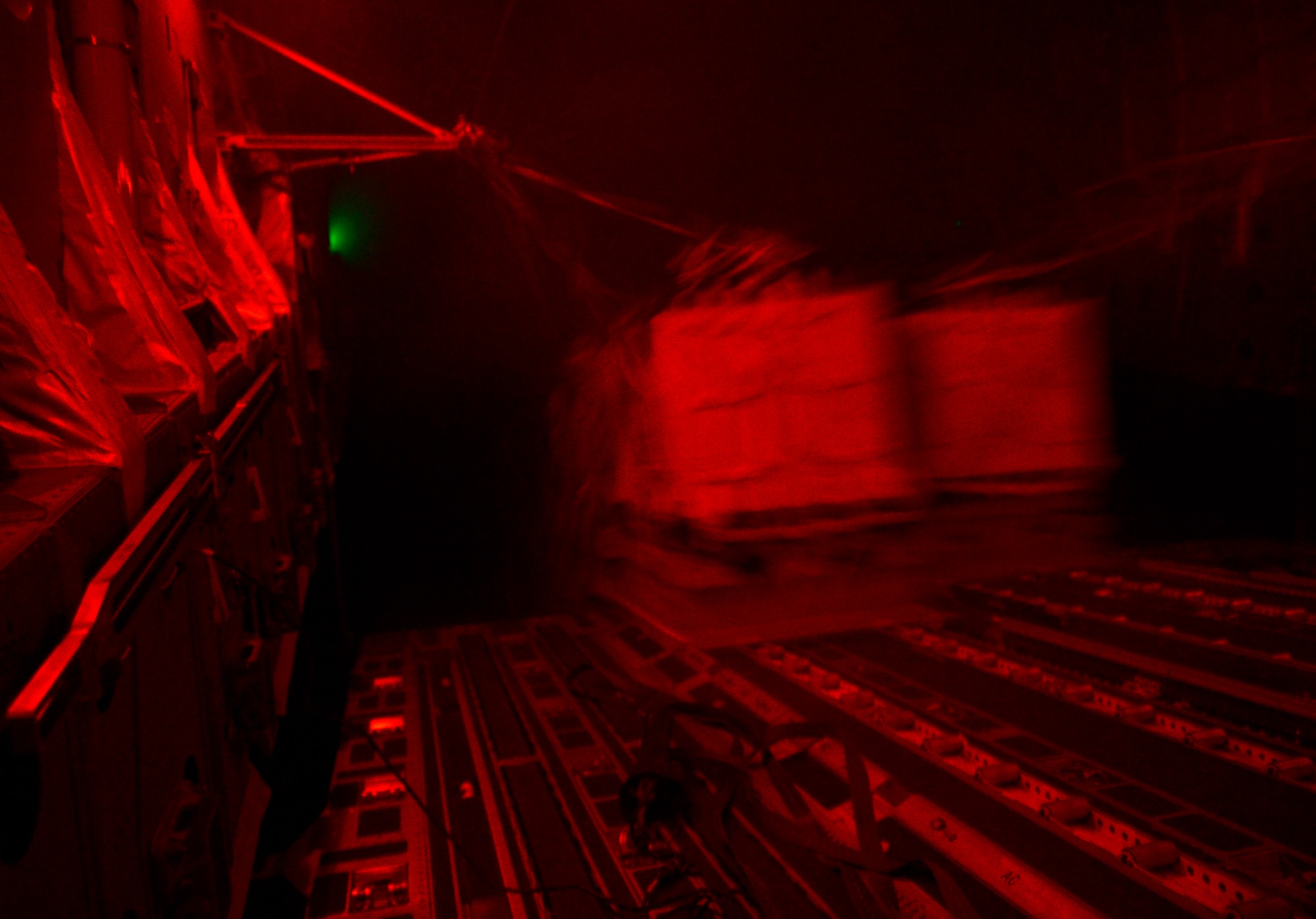 Container delivery system bundles exit a U.S. Air Force C-17 Globemaster III during a humanitarian airdrop over Amirli, Iraq, Aug. 31, 2014. The two C-17s dropped 79 container delivery system bundles of fresh drinking water totaling 7,513 gallons. In addition, the two U.S. C-130s aircraft dropped 30 bundles totaling 3,032 gallons of fresh drinking water and 7,056 meals ready to eat. (U.S. Air Force photo by Staff Sgt. Vernon Young Jr.)
