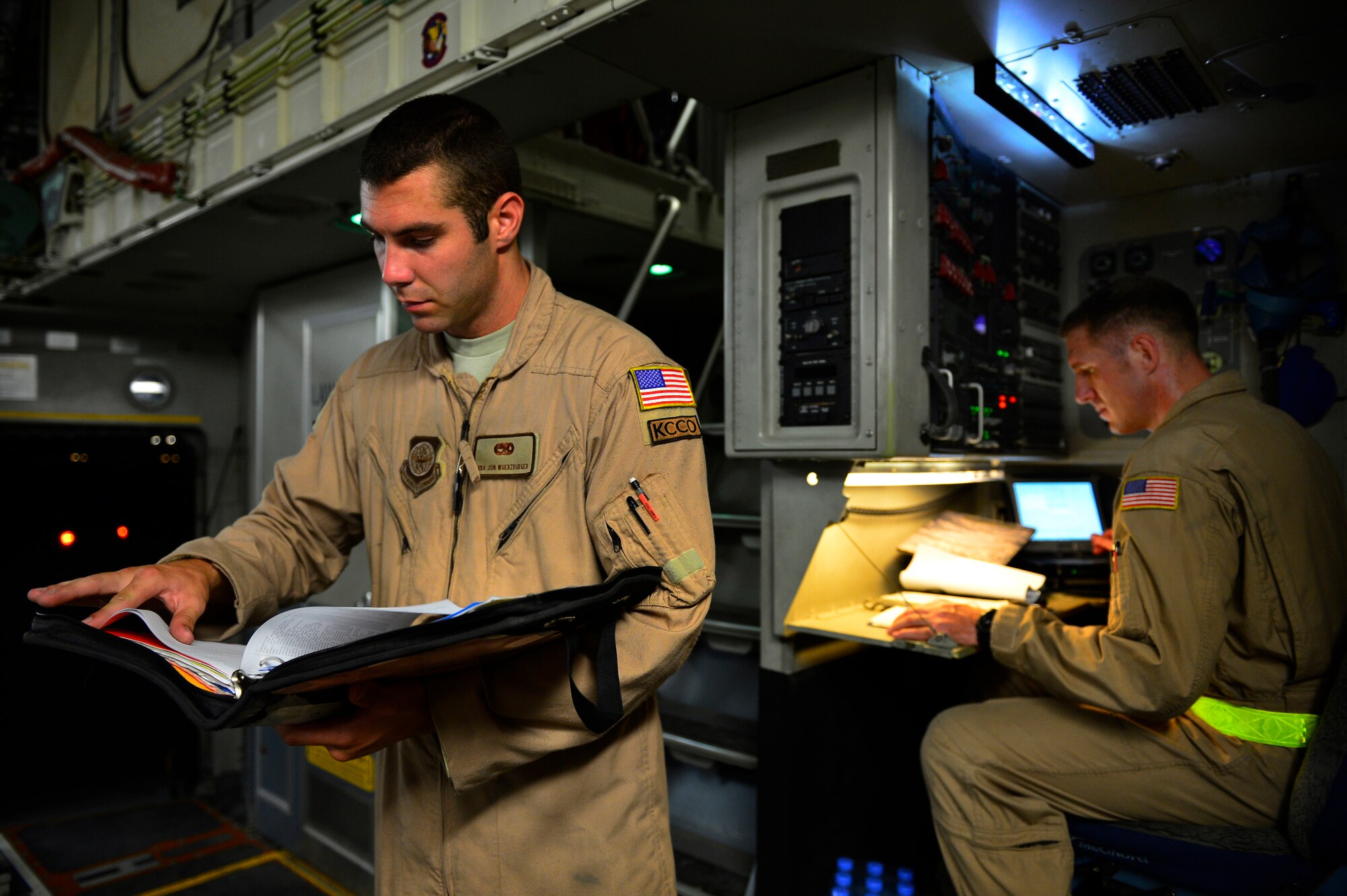 Senior Airman Jon Woerzburger, 816th Expeditionary Airlift Squadron, C-17 Globemaster III flying crew chief, reviews weight management records with loadmaster Tech. Sgt. Robert Hardesty, prior to a humanitarian airdrop mission over Amirli, Iraq, Aug. 30, 2014. This airdrop was conducted from multiple airbases within the U.S. Central Command area of responsibility and included two U.S. C-17 and two U.S. C-130 aircraft that together dropped a total of 109 bundles of supplies. (U.S. Air Force photo by Staff Sgt. Vernon Young Jr.)