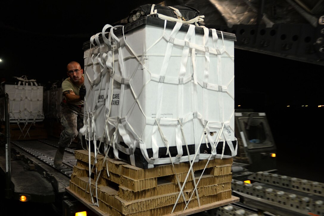U.S. Air Force Tech. Sgt. Michael EtterleyCrown pushes a container