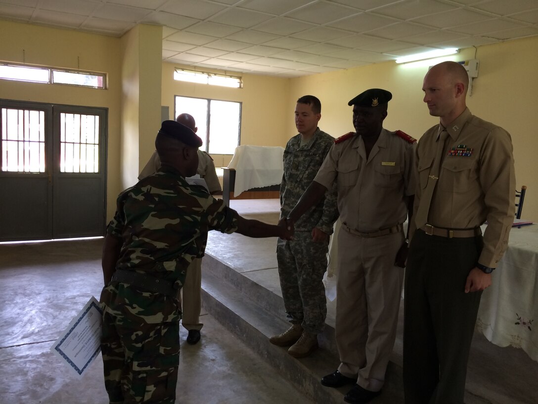 Graduates from the Basic Intelligence Course in Burundi are congratulated by the chief military intelligence officer of Burundi and the class instructor, U.S. Marine Corps Capt. Dustin Partridge. The U.S. Africa Command sponsored, Marine Forces Africa-led engagement was designed to enhance the host nation’s contribution to the African Union Mission to Somalia, which the Burundi Army has supported since 2007. 