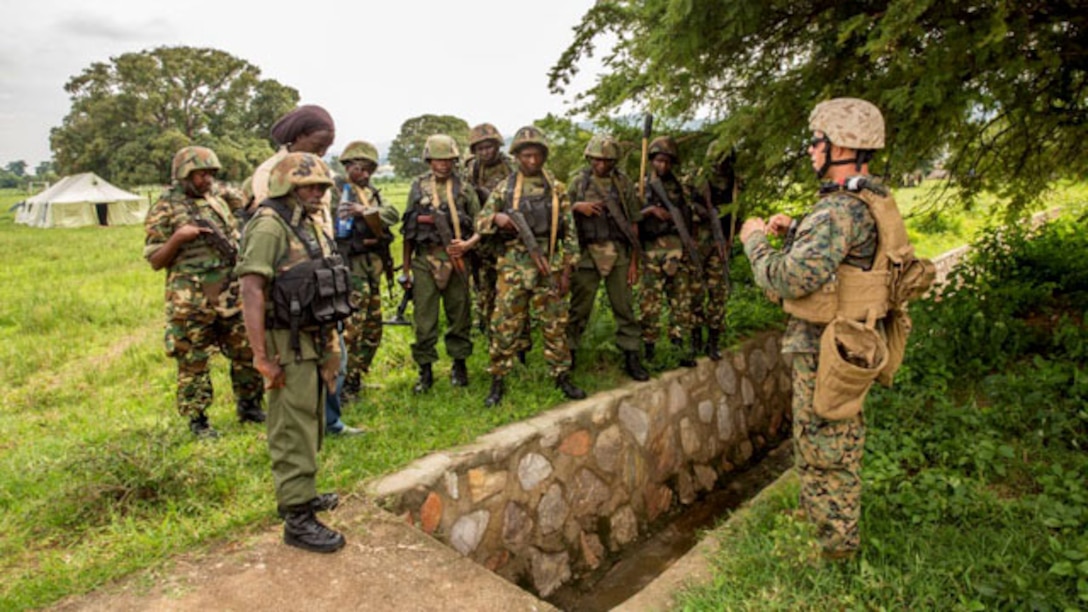 Staff Sergeant Gabriel Schaller discusses countering-improvised explosive devices techniques with soldiers from the Burundi National Defense Force in Bujumbura, Burundi, Nov. 6, 2014. Schaller is an explosive ordnance disposal technician with SPMAGTF-Crisis Response-Africa, training alongside the BNDF, teaching basic infantry tactics, engineering, logistical support, C-IED, lifesaving techniques and convoy operations to prepare them for an upcoming deployment in support of the African Union Mission in Somalia (AMISOM). Knowing what signs to look for and common places for hiding IEDs can save lives, especially in Somalia, where extremist regimes use them. (U.S. Marine Corps photo by Cpl. Shawn Valosin)