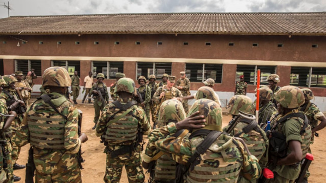 Sergeant Jay Schenkel II speaks with soldiers with the Burundi National Defense Force (BNDF) after conducting practical application drills for improvised explosive device sweeping while patrolling in Bujumbura, Burundi, Nov. 6, 2014. Schenkel is an explosive ordnance disposal technician with SPMAGTF-Crisis Response-Africa training alongside the BNDF, teaching basic infantry tactics, engineering, logistical support, countering-IED, lifesaving techniques and convoy operations to prepare them for an upcoming deployment in support of the African Union Mission in Somalia (AMISOM). (U.S. Marine Corps photo by Cpl. Shawn Valosin)