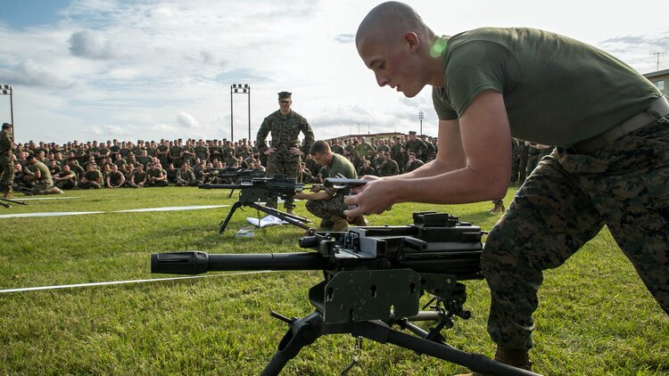 Lance Cpl. Austin Nelson, front, races, Sgt. Joshua Houck to reassemble a MK 19 40 mm automatic grenade launcher Nov. 14 while participating in the weapons relay during the Shanghai Commanders’ Cup at Camp Schwab. The weapons relay tested teams of Marines to disassemble and reassemble six weapons ranging from the smallest, M9A1 9 mm service pistol, and progressing to the largest, MK 19 40 mm automatic grenade launcher. Nelson is from West Jordan, Utah, and a machine-gunner with 1st Battalion, 1st Marine Regiment, currently assigned to 4th Marine Regiment, 3rd Marine Division, III Marine Expeditionary Force, under the unit deployment program. Houck is from Rochester, New York, and a machine-gunner with 1st Battalion, 3rd Marines, currently assigned to 4th Marines. 