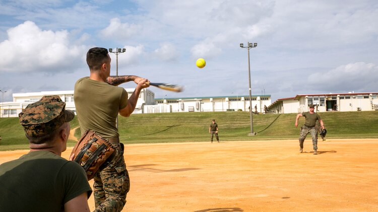 A Marine connects with a arching pitch while playing softball Nov. 14 during the Shanghai Commanders’ Cup at Camp Schwab. Today was about setting some time aside for the Marines to have fun, according to Col. David L. Odom. The Marines are from various units with 4th Marine Regiment, 3rd Marine Division, III Marine Expeditionary Force. Odom is from Hartsville, South Carolina, and the commanding officer of 4th Marines. 