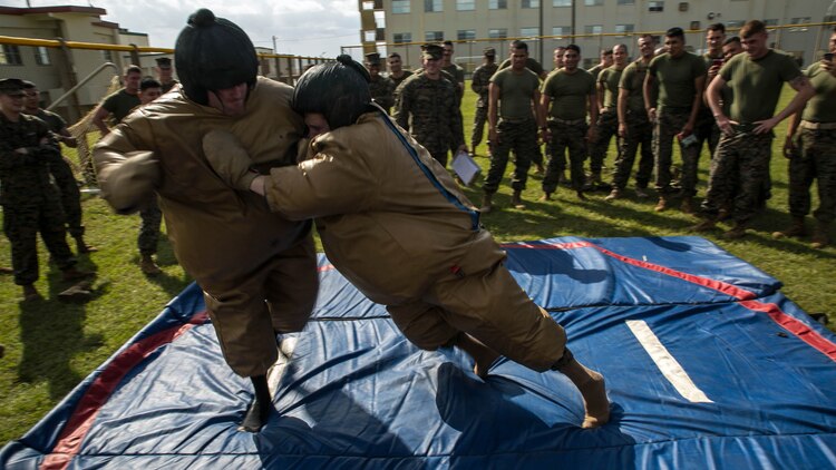 Two Marines compete in a sumo wrestling match Nov. 14 during the Shanghai Commanders’ Cup at Camp Schwab. Today was about setting some time aside for the Marines to have fun, according to Col. David L. Odom. The Marines are from various units with 4th Marine Regiment, 3rd Marine Division, III Marine Expeditionary Force. Odom is from Hartsville, South Carolina, and the commanding officer of 4th Marines.