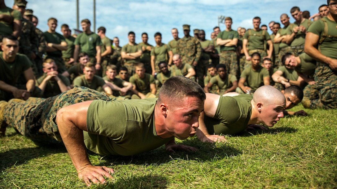 Lance Cpl. Ronald Hinson from Heath Springs, South Carolina, competes in the push up challenge portion of the Shanghai Commanders’ Cup Nov. 14 at Camp Schwab. The meet tested the Marines in nine categories, ranging from fun events like softball and sumo wrestling to pull-up and push-up competitions. Every event was performed in a team setting further reinforcing camaraderie and cohesion. Hinson is a cyber-network operator with 1st Battalion, 1st Marine Regiment, currently assigned to 4th Marine Regiment, 3rd Marine Division, III Marine Expeditionary Force, under the unit deployment program. 