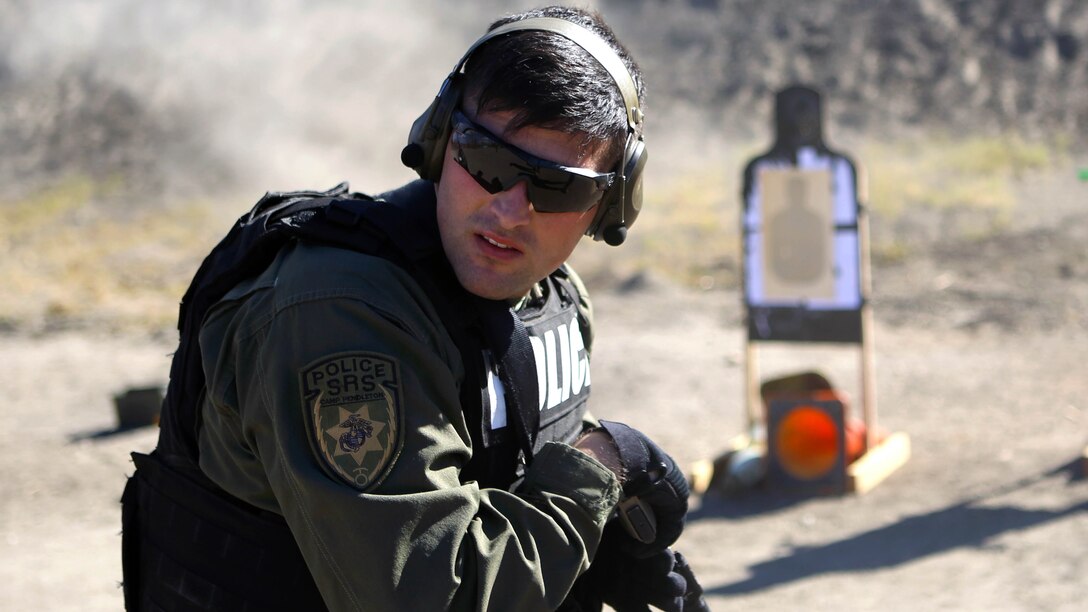 Cpl. Tyler Raffaele, an entry team breecher with the Special Reaction Team, Marine Corps Police Department, Security Emergency Services Battalion, performs a scan of his surroundings immediately following a course of fire during a quarterly SRT qualification at Range 300, Nov. 20.  The scan is a tactic used to remain aware of your surroundings and break tunnel vision in combat.