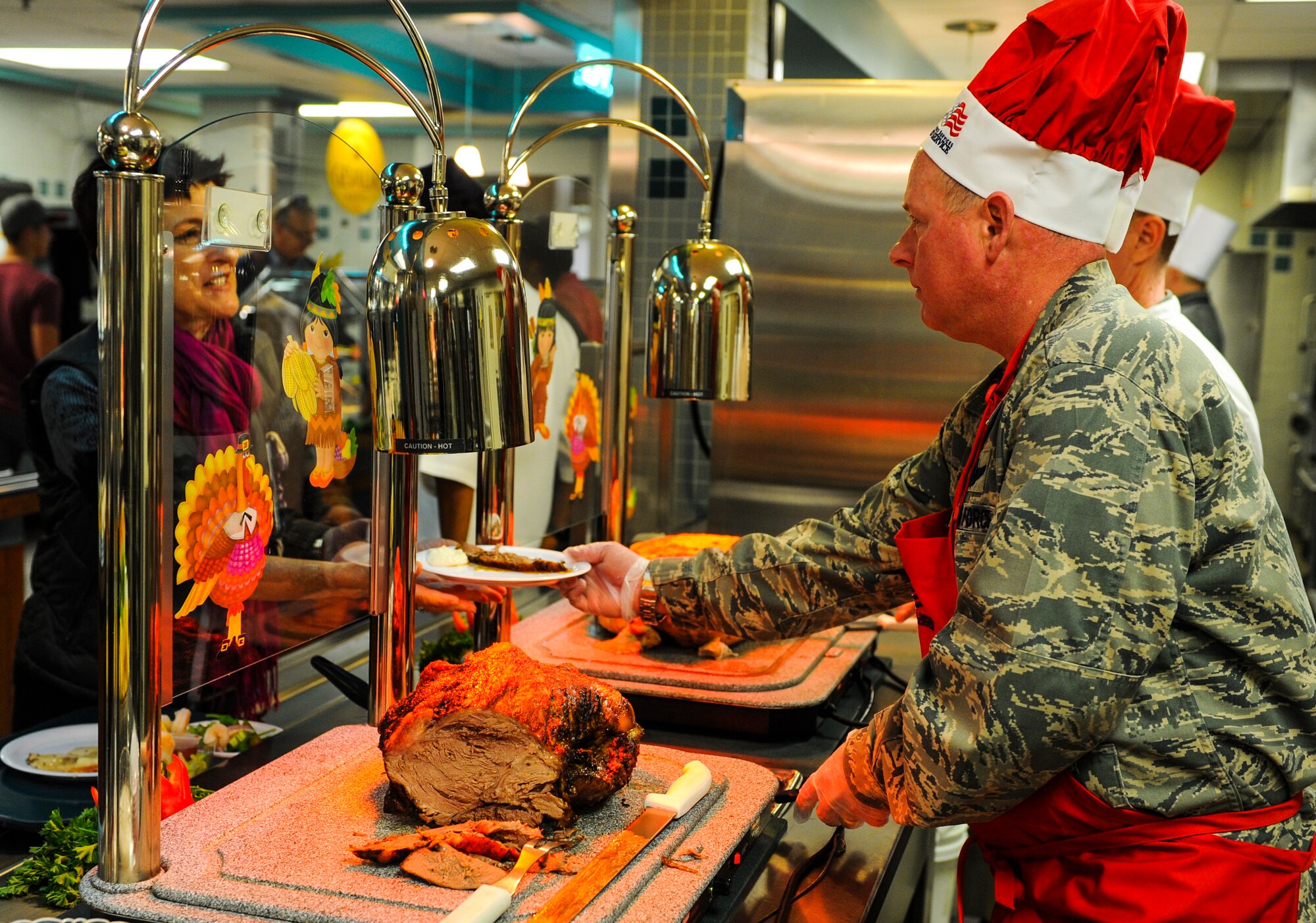 Maj. Gen. Morris Haase, Air Force Special Operations Command vice commander, serves roast beef to visitors of the Reef Dining Facility at Hurlburt Field, Fla., Nov. 27, 2014. The Reef Dining Facility was open to Air Commandos and retirees for Thanksgiving lunch. (U.S. Air Force photo/Senior Airman Christopher Callaway) 