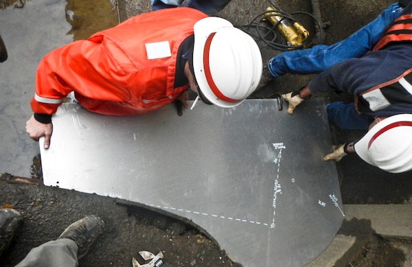 Kevin McConnell and Bob Szemanski check the shape of the miter sill using an aluminum pattern.
When the repair party departed on Nov. 19, its month-plus stay yielded a more tightly sealed chamber and a more reliable facility necessary to keep navigation moving on the upper Mon. 