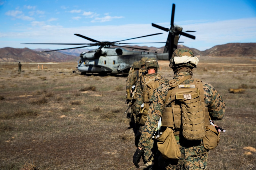 U.S. Marines with the Maritime Raid Force’s Security Element, 15th Marine Expeditionary Unit, load onto a CH-53 Super Stallion during interoperability training aboard Camp Pendleton, Calif., Nov. 19, 2014. Interop gives the 15th MEU’s MRF and Security Element an opportunity to work together and support each other in preparation for a deployment in the spring. (U.S. Marine Corps photo by Cpl. Anna Albrecht/Released)