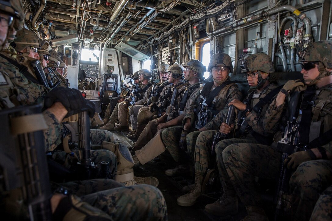U.S. Marines with the Maritime Raid Force and Security Element of the 15th Marine Expeditionary Unit, ride in a CH-53 Super Stallion during interoperability training aboard Camp Pendleton, Calif., Nov. 20, 2014. Interop gives the 15th MEU’s MRF and Security Element an opportunity to work together and support each other in preparation for a deployment in the spring. (U.S. Marine Corps photo by Cpl. Anna Albrecht/Released)