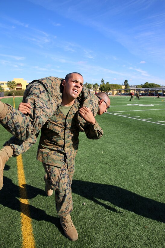 Recruit Isaac V. Mota, Platoon 1014, Alpha Company, 1st Recruit Training Battalion, conducts a fireman’s carry during the Combat Fitness Test at Marine Corps Recruit Depot San Diego, Calif., Nov. 20.  Mota is a Los Angeles native and was recruited out of Recruiting Sub Station Downey, Calif.