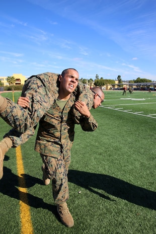 Recruit Isaac V. Mota, Platoon 1014, Alpha Company, 1st Recruit Training Battalion, conducts a fireman’s carry during the Combat Fitness Test at Marine Corps Recruit Depot San Diego, Calif., Nov. 20.  Mota is a Los Angeles native and was recruited out of Recruiting Sub Station Downey, Calif.