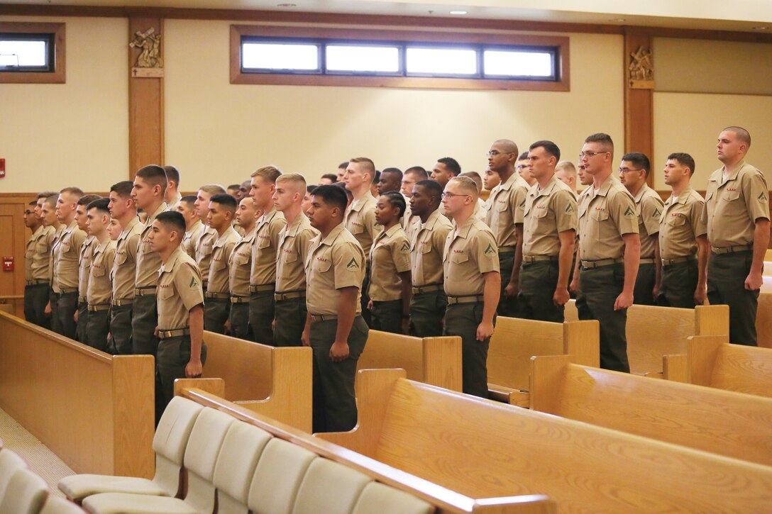 MARINE CORPS BASE HAWAII - The graduating class of 52 lance corporals stand at attention as the leaders of the Lance Corporal Leadership and Ethics Seminar enter the Chaplain Joseph W. Estabrook Chapel, Nov. 21, 2014. (U.S. Marine Corps photo by Lance Cpl. Khalil Ross)