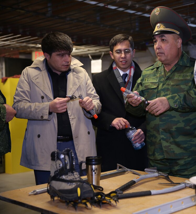 Maj. Gen. Latif Fayziev, advisor to the minister, Tajikistan Ministry of Defense; Daler Safarov, attaché for American and European countries, Tajikistan  Ministry of Foreign Affairs; and Otabek Sindarov, interpreter, examine glacier climbing gear at Marine Corps Mountain Warfare Training Center, Bridgeport, Calif., Nov. 19, 2014. The gear that was displayed is normally issued to service members while they are in training at MCMWTC. (Official Marine Corps photo by Lance Cpl. Thomas Mudd/ Released)