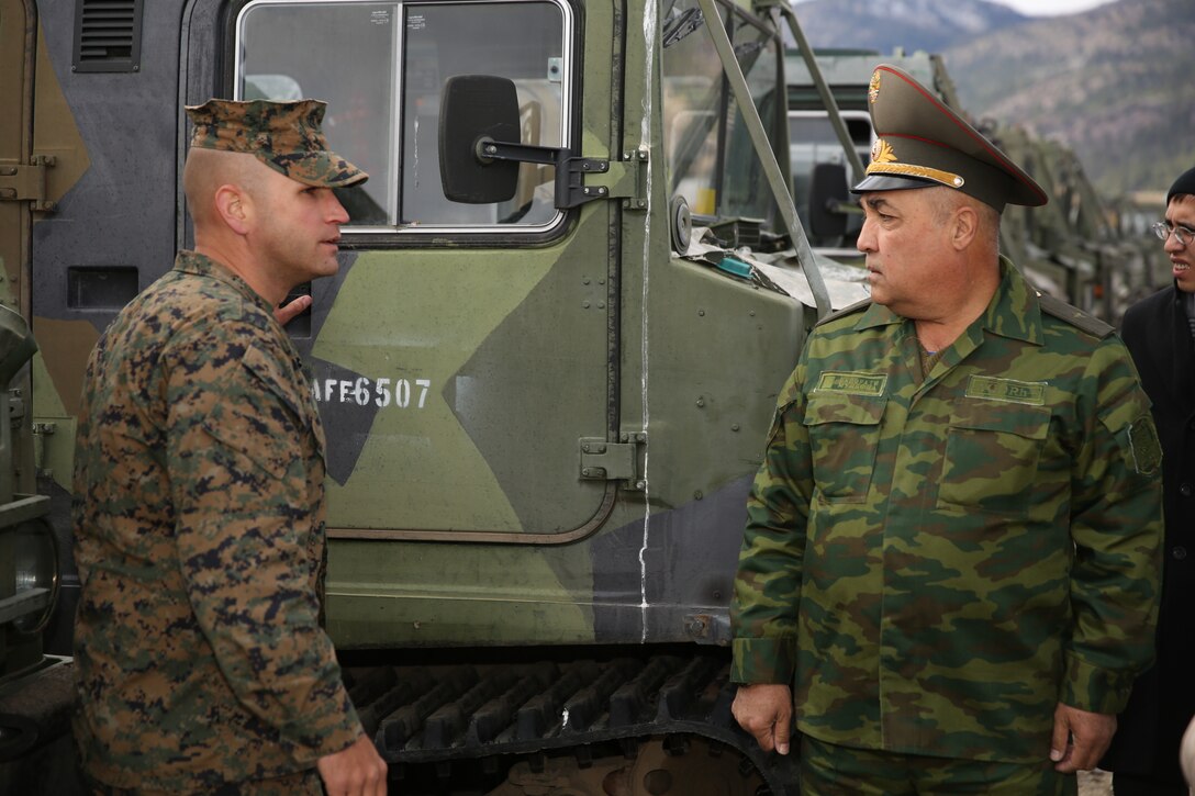 Capt. Seth Miller, mountain leader officer-in-charge, Marine Corps Mountain Warfare Training Center, displays an M973A1 Small Unit Support Vehicle to Maj. Gen. Latif Fayziev, advisor to the minster, Tajikistan Ministry of Defense, at MCMWTC, Bridgeport, Calif., Nov. 19, 2014. These vehicles come in two variants, the transport variant and the supply variant. (Official Marine Corps photo by Lance Cpl. Thomas Mudd/Released)