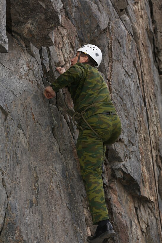 Col. Jahongir Nazaraliev, chief personnel directorate, Tajikistan Ministry of Defense, climbs a rock face at the Marine Corps Mountain Warfare Training Center, Bridgeport, Calif., Nov. 19, 2014. This demonstration was part of a mountain assault training course. (Official Marine Corps photo by Lance Cpl. Thomas Mudd/Released)