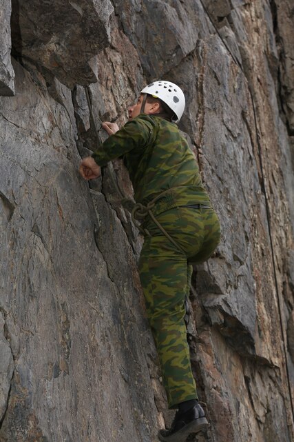 Col. Jahongir Nazaraliev, chief personnel directorate, Tajikistan Ministry of Defense, climbs a rock face at the Marine Corps Mountain Warfare Training Center, Bridgeport, Calif., Nov. 19, 2014. This demonstration was part of a mountain assault training course. (Official Marine Corps photo by Lance Cpl. Thomas Mudd/Released)