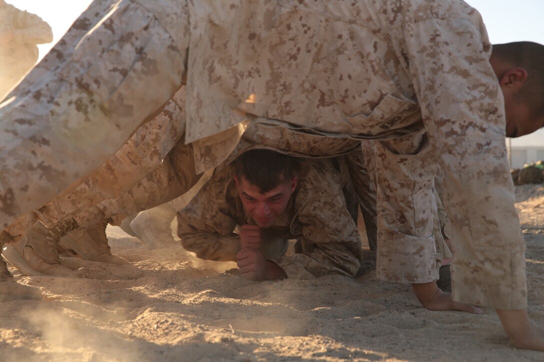 Marines and sailors of 3rd Light Armor Reconnaissance Battalion, build a bridge during the first event of the 3rd LAR field meet aboard the Combat Center, Nov. 20, 2014. As soon as a training event is completed, planning for the next one begins. (Official Marine Corps photo by Pfc. Medina Ayala-Lo/Released)