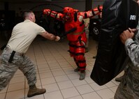 Airman 1st Class Garrett Schmitt, 28th Civil Engineer Squadron water fuels maintenance technician, strikes Master Sgt. Thomas Carpino, 28th Security Forces Squadron operations section chief, during ASP baton training as part of the 28th SFS augmentee training program at Ellsworth Air Force Base, S.D., Nov. 20, 2014. The augmentee training program equips base personnel with the basic fundamentals of security forces tasks and procedures to provide them with the skills required to assist security forces members should they be called upon. (U.S. Air Force photo by Senior Airman Anania Tekurio/Released)