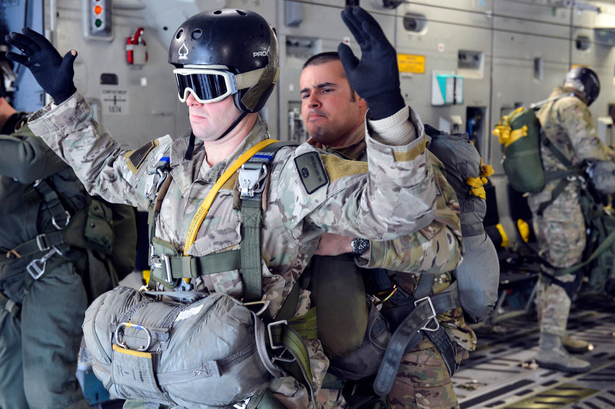 Staff Sgt. Raymond Caballero-Perez (right), 22nd Training Squadron parachuting shop NCO in charge, performs a jump master inspection on Senior Airman Christopher Henry (left), 22nd TRS Survival, Evasion, Resistance, Escape specialist, prior to a static line jump from a McChord Field C-17 Globemaster III during jump training Nov. 24, 2014, at Fairchild Air Force Base, Wash. Caballero-Perez and Henry were two of the 24 Airmen who performed static line jump training from the McChord Field aircraft. (U.S. Air Force photo/Staff Sgt. Russ Jackson)