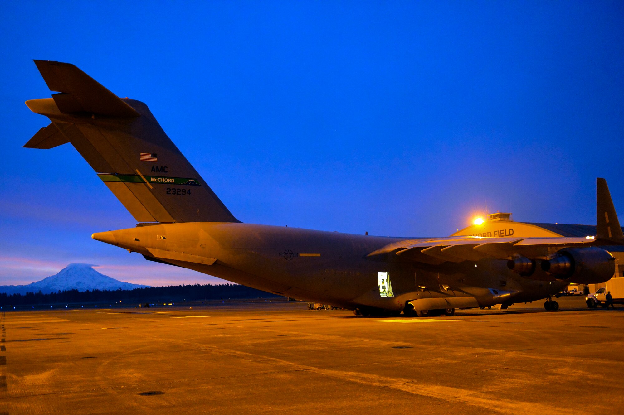 The sun begins to rise over Mount Rainier and a C-17 Globemaster lll before a McChord aircrew boards it to fly to Fairchild Air Force Base to conduct jump training with Airmen from the 22nd Training Squadron Nov. 24, 2014, at Joint Base Lewis-McChord, Wash. After the crew readied the jet for take-off, they launched into the clear skies above Mount Rainier. (U.S. Air Force photo/Staff Sgt. Russ Jackson)