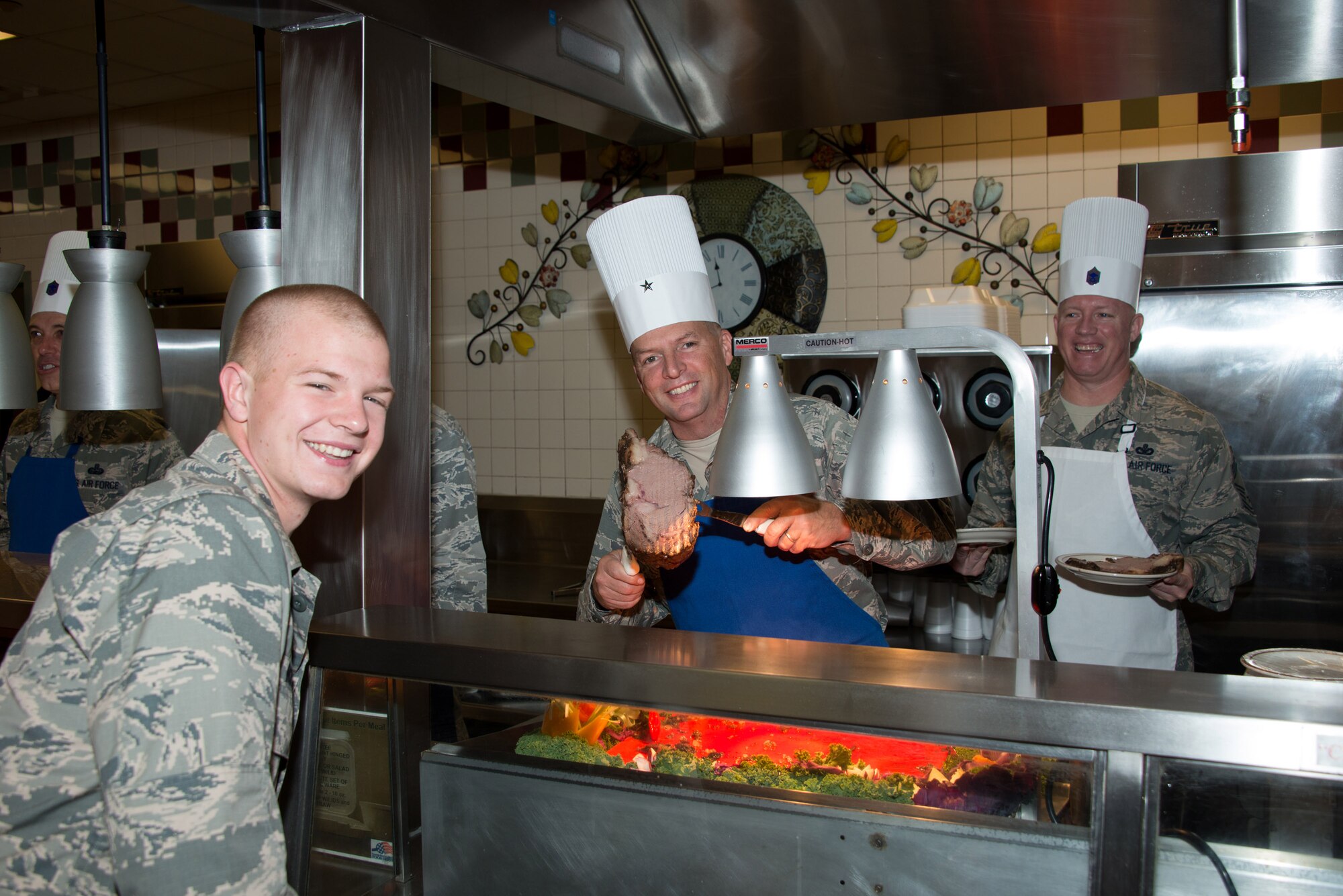 Brig. Gen. Patrick Higby, 81st Training Wing commander, serves Airman Basic Cairo Ingram, 334 Training Squadron student, prime rib Nov.27, 2014, at the Azalea Dining Facility, Keesler Air Force Base, Miss.  Ingram was one of many Airmen in technical training who stayed on base during the Thanksgiving holiday. (U.S. Air Force photo by Marie Floyd)