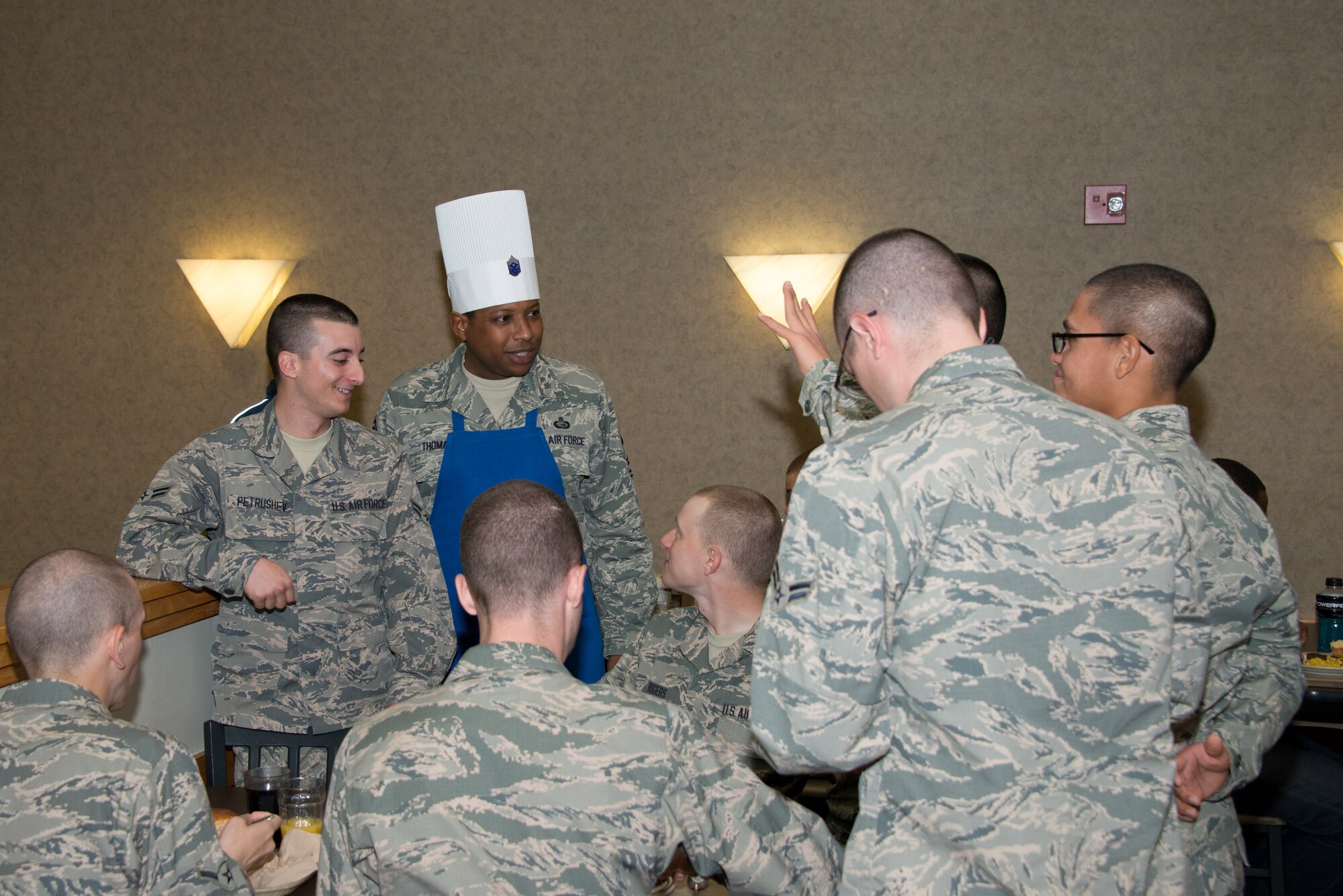 Chief Master Sgt. Farrell Thomas, 81st Training Wing command chief, visits with Airmen on Thanksgiving Day, Nov.27, 2014, at the Azalea Dining Facility, Keesler Air Force Base, Miss. Keesler leadership served meals and interacted with technical training students who did not go home for the holiday. (U.S. Air Force photo by Marie Floyd)