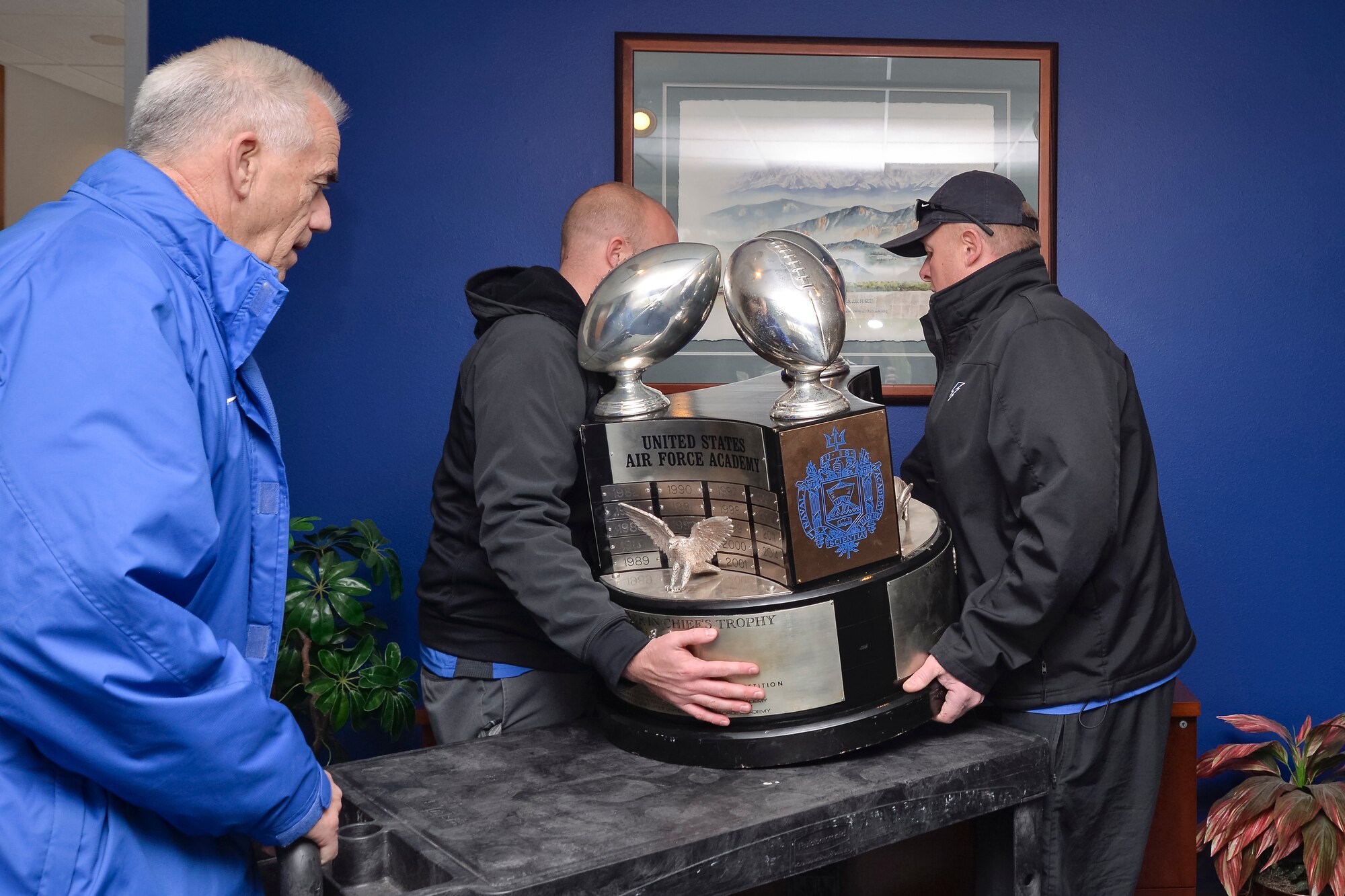 The Commander In Chief's Trophy is delivered to the lobby of the 10th Air Base Wing Dec. 1. The trophy is scheduled to be seen at the Visitor Center, the U.S.  Air Force Academy Preparatory School, the High Country Dining Facility and other locations during the coming months. (U.S. Air Force photo/Liz Copan) 