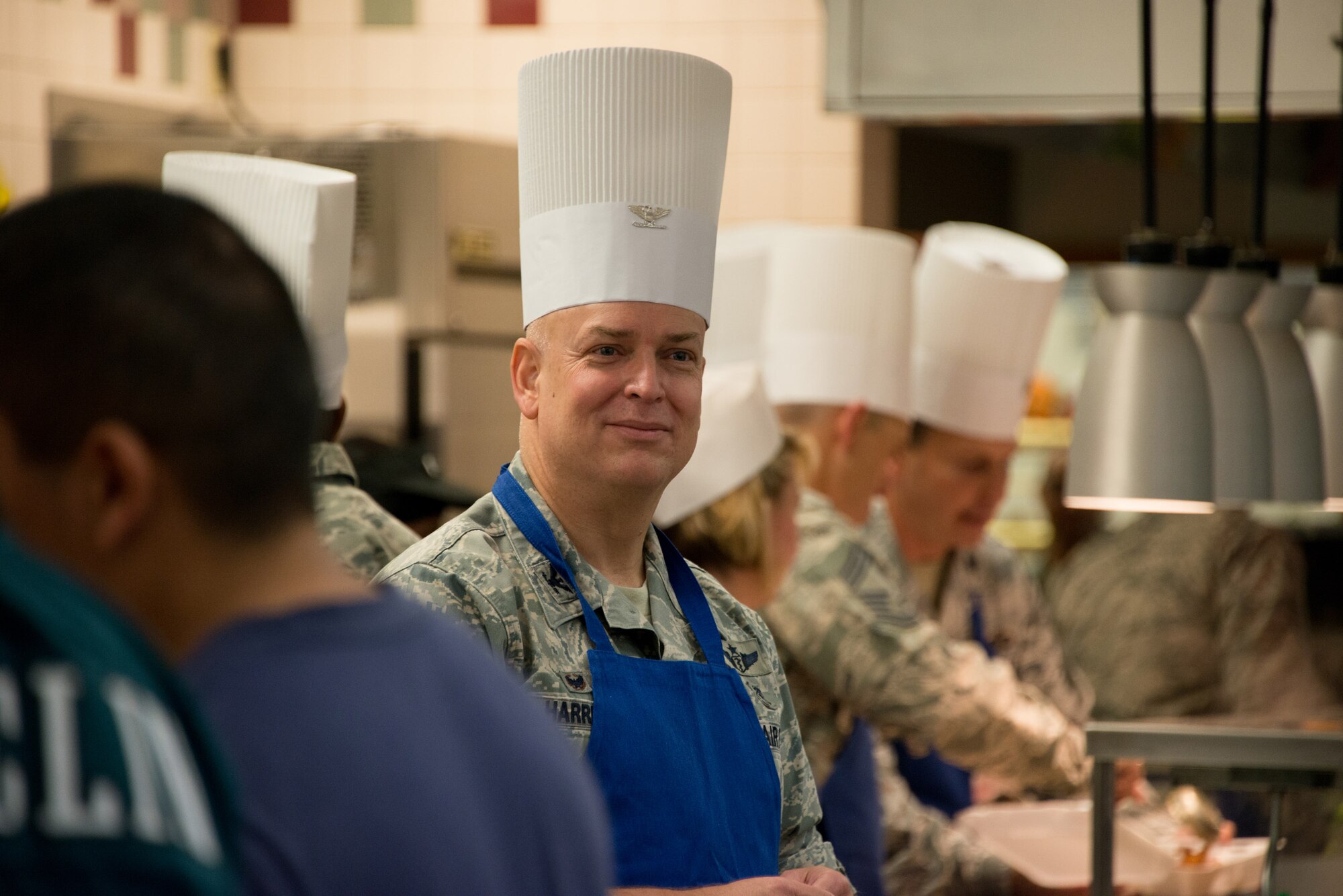 Col. (Dr.) Thomas W. Harrell, 81st Medical Group commander, serves meals to Airmen on Thanksgiving Day, Nov. 27, 2014, at the Azalea Dining Facility, Keesler Air Force Base, Miss. Keesler leadership served meals and interacted with technical training students who did not go home for the holiday. (U.S. Air Force photo by Marie Floyd)