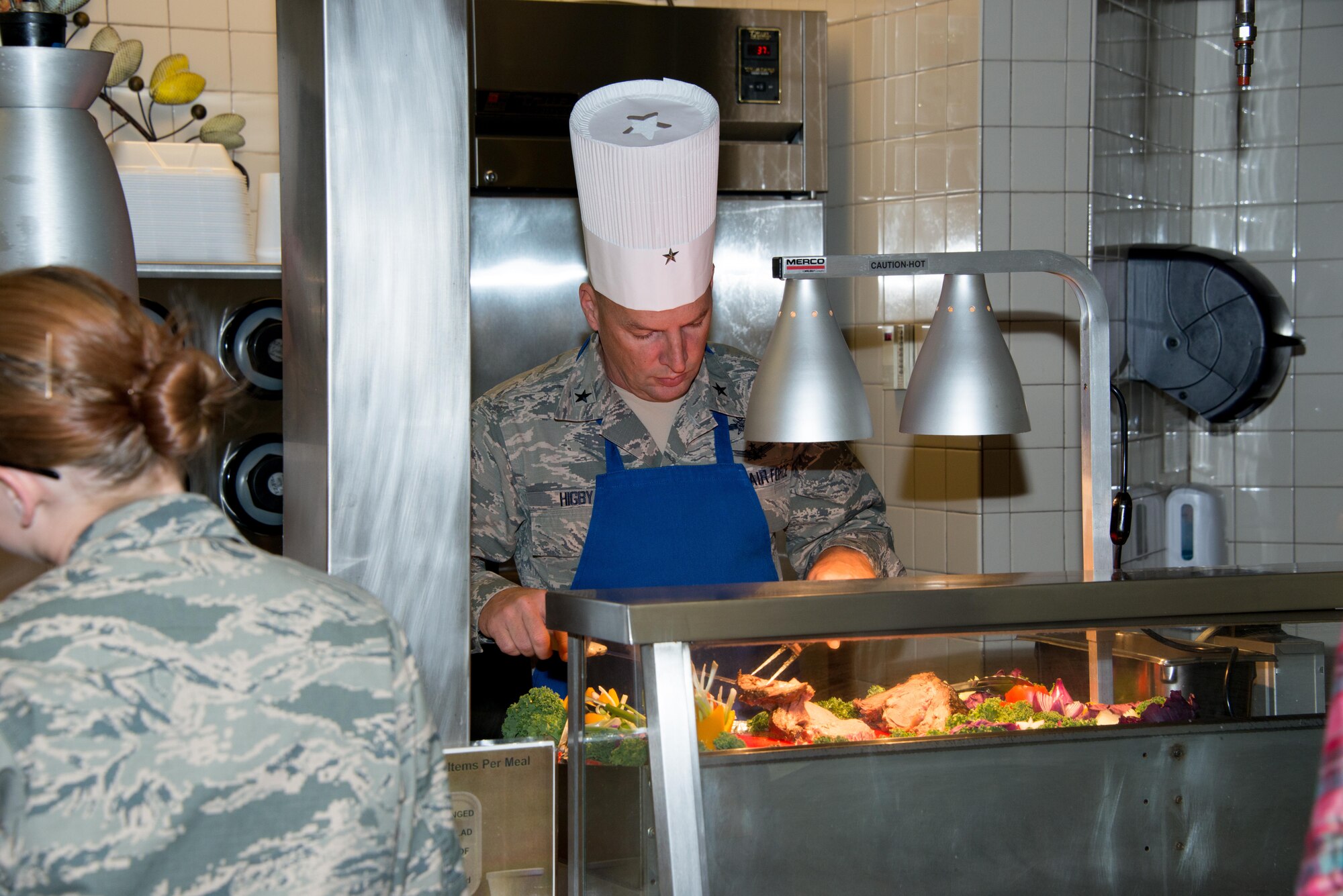 Brig. Gen. Patrick Higby, 81st Training Wing commander, slices and serves prime rib to Airmen on Thanksgiving Day, Nov.27, 2014, at the Azalea Dining Facility, Keesler Air Force Base, Miss. It is traditional at Keesler for commanders, first sergeants and superintendents to take time out of their holiday to serve a Thanksgiving meal at the dining facilities to technical training Airmen. (U.S. Air Force photo by Marie Floyd)