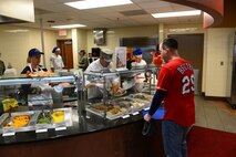 Col. Kevin Kennedy, 28th Bomb Wing commander, serves meals to Airmen at the Raider Café dining facility at Ellsworth Air Force Base, S.D., Nov. 27, 2014. Senior leaders from around base gather annually in an effort to ensure that Ellsworth Airmen, as a part of the Air Force family, share in a Thanksgiving meal. (U.S. Air Force photo by Senior Airman Zachary Hada/Released)