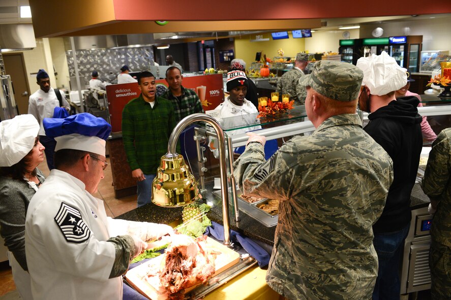 Senior leaders of team Ellsworth work alongside members from the 28th Force Support Squadron at the Raider Café dining facility to serve Thanksgiving meals to Airmen at Ellsworth Air Force Base, S.D., Nov. 27, 2014. The 28th FSS coordinated with senior leadership base-wide to ensure this annual event was available to all Airmen who may not have been able to enjoy Thanksgiving with their families. (U.S. Air Force photo by Senior Airman Zachary Hada/Released)