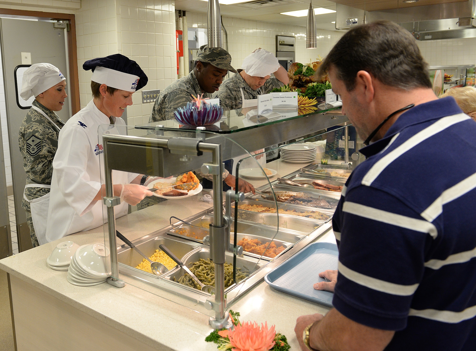 Col. Kristin Goodwin, 2nd Bomb Wing commander, serves food during the Red River Dining Facility Thanksgiving lunch on Barksdale Air Force Base, La., Nov. 27, 2014. Leadership across the base volunteered to show support to Airmen who weren’t able to be with their families for the holiday. (U.S. Air Force photo/ Airman 1st Class Curt Beach)