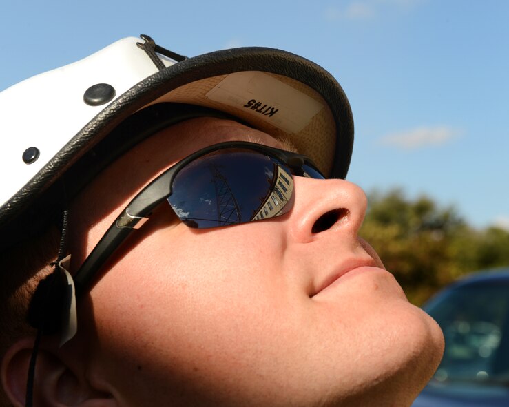 Staff Sgt. John Hines, 2nd Communications Squadron cable and antenna systems, monitors 2nd CS Airmen scale a communications tower on Barksdale Air Force Base, La., Nov. 19, 2014. Airmen from the 2nd CS cable and antenna maintenance are responsible for maintaining all physical and fiber optic structures. There is a total of 90,000 miles of cable on base. (U.S. Air Force photo/Senior Airman Benjamin Gonsier)