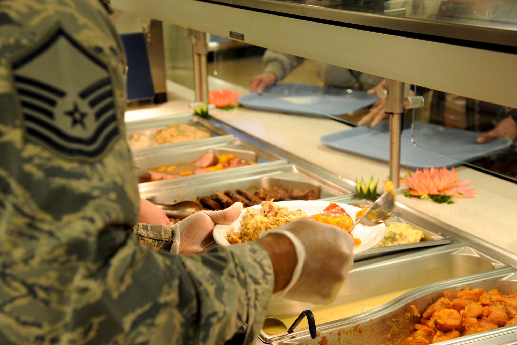 A Barksdale Airman prepares a plate during the Red River Dining Facility Thanksgiving lunch on Barksdale Air Force Base, La., Nov. 27, 2014. The traditional meal included turkey, ham, beef, a variety of sides and dessert. (U.S. Air Force photo/ Senior Airman Jannelle Dickey)