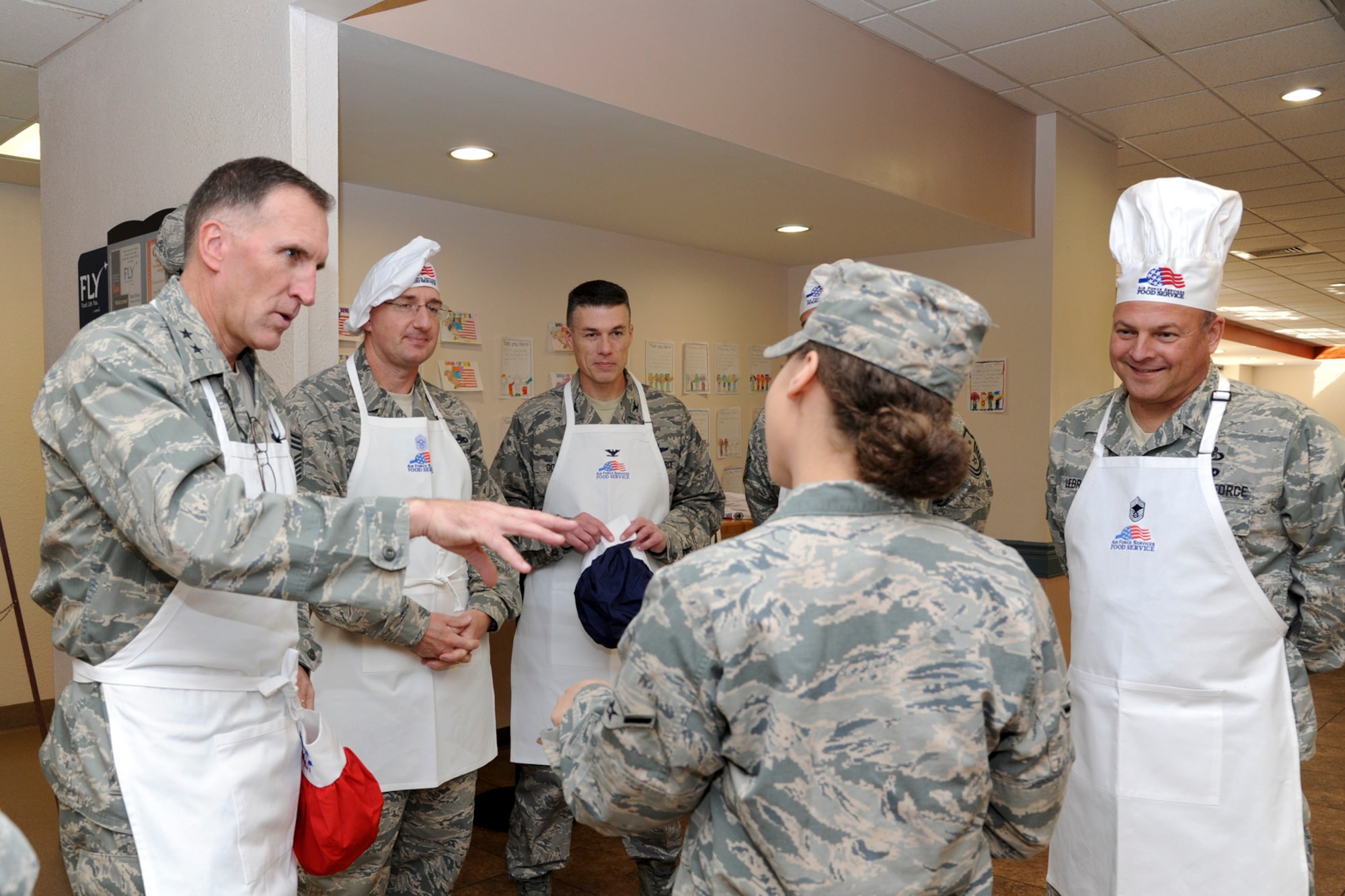 Airman Janaye Galbraith, 2nd Force Support Squadron, briefs senior leadership on food handling guidelines during the Red River Dining Facility Thanksgiving lunch on Barksdale Air Force Base, La., Nov. 27, 2014. The leadership served Thanksgiving meals as an annual Air Force wide event to ensure Airmen get a home cooked meal during the holidays. (U.S. Air Force photo/ Senior Airman Jannelle Dickey)