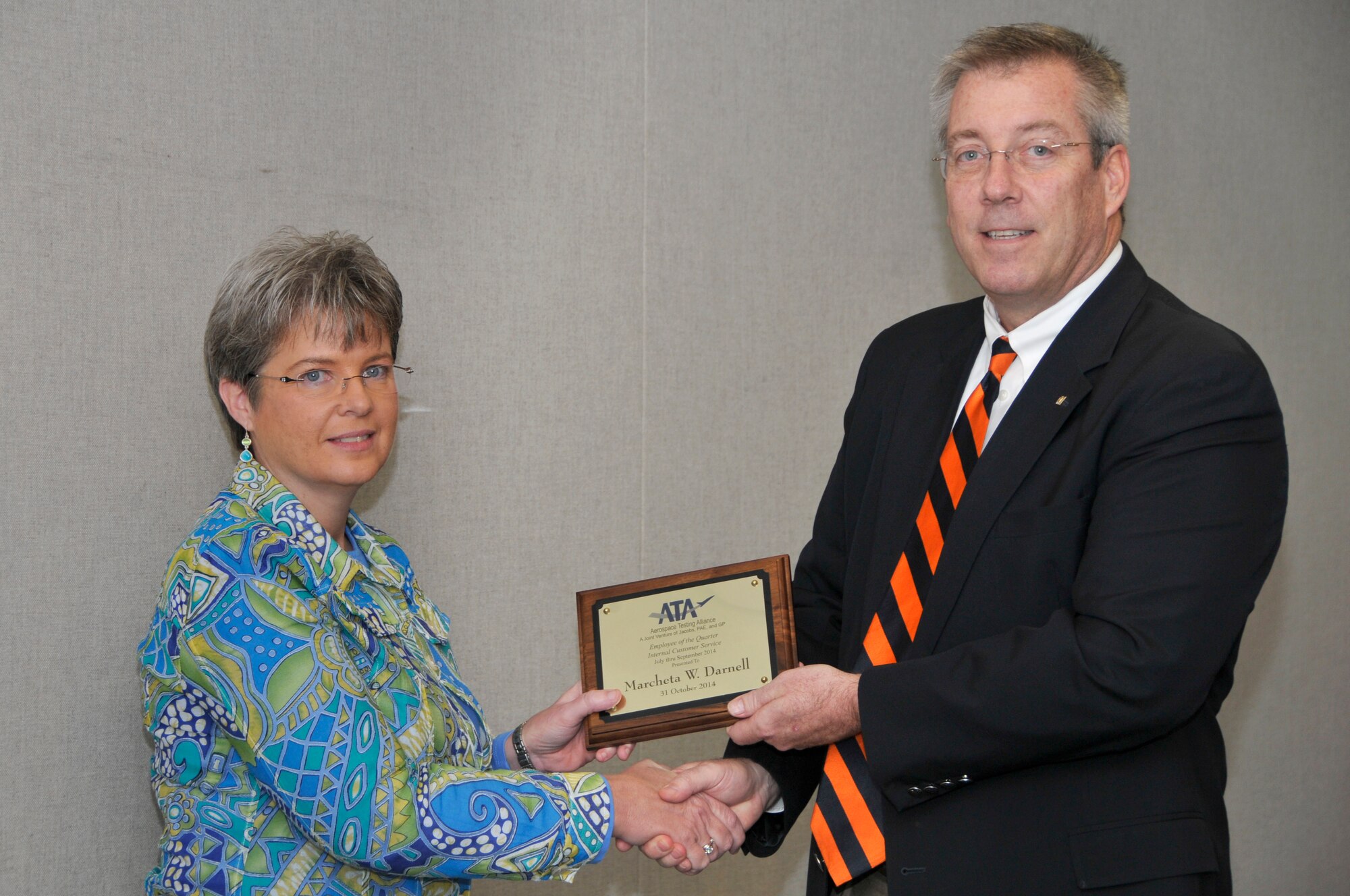 Marcheta Darnell (left), with the ATA Test Assets and Support Department, accepts the ATA Internal Customer Service Excellence of the Quarter Award from ATA Deputy General Manager Jeff Haars.