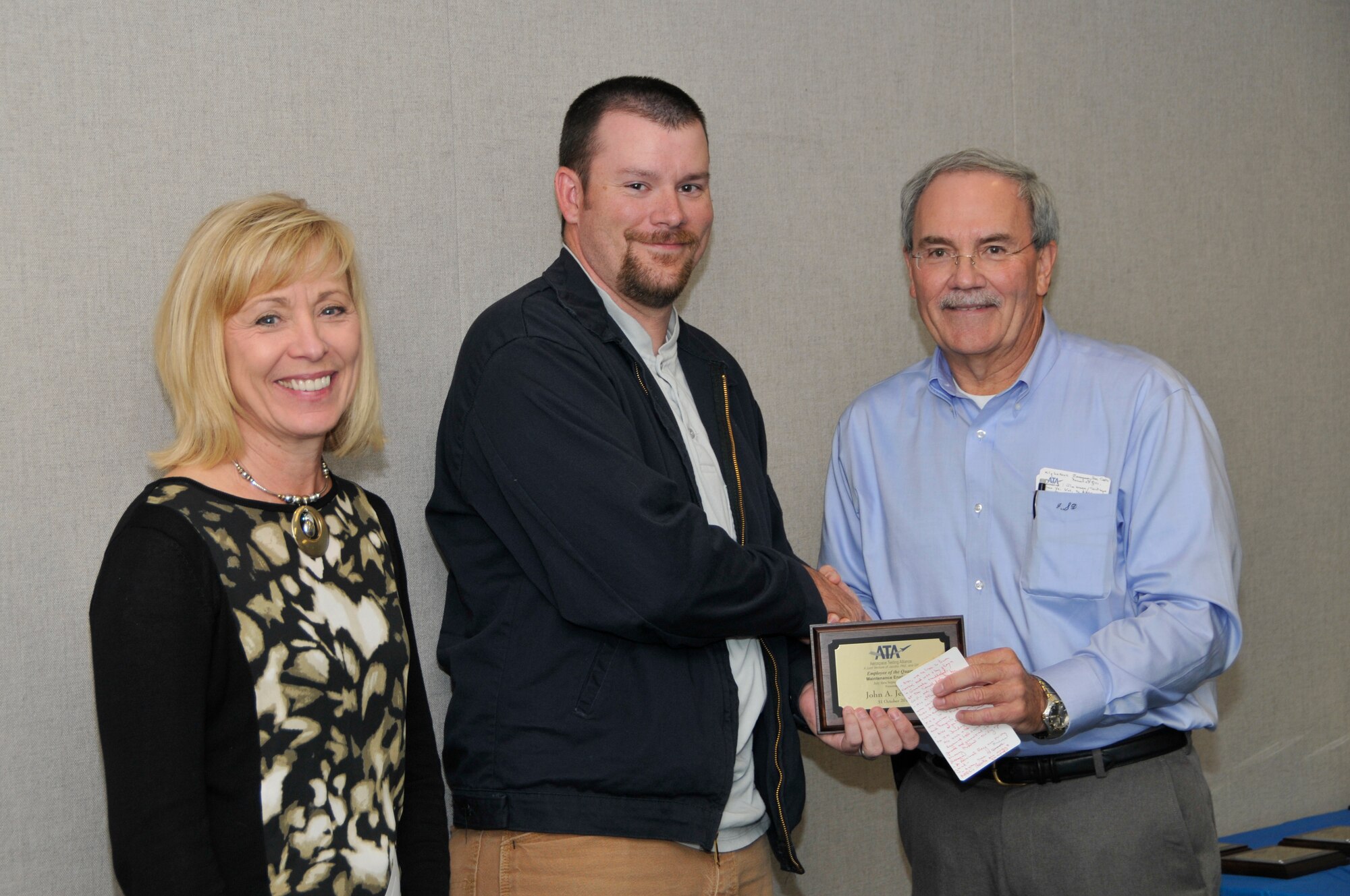 John Jenkins (center), with the ATA Integrated Test and Evaluation Department, accepts the ATA Operations and System Engineer of the Quarter Award from Dave Simmons (right), the ATA deputy director of the Mission Support Department, and Debbie Bayer, the ATA deputy director of the Test Assets and Support Department.