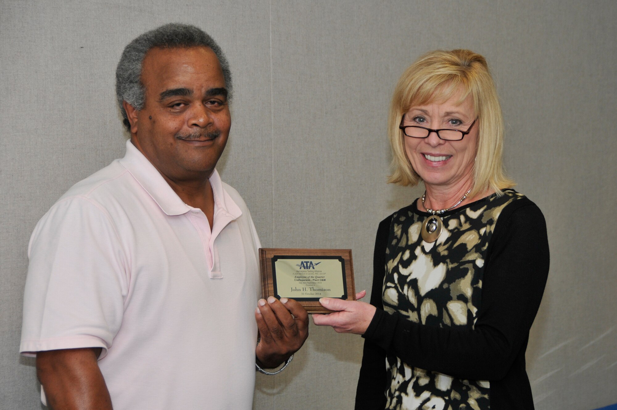 John Thomison (left), with the ATA Test Assets and Support (AM) Department, accepts the ATA Craftsperson of the Quarter Award from Debbie Bayer, the ATA deputy director of the ATA AM Department.