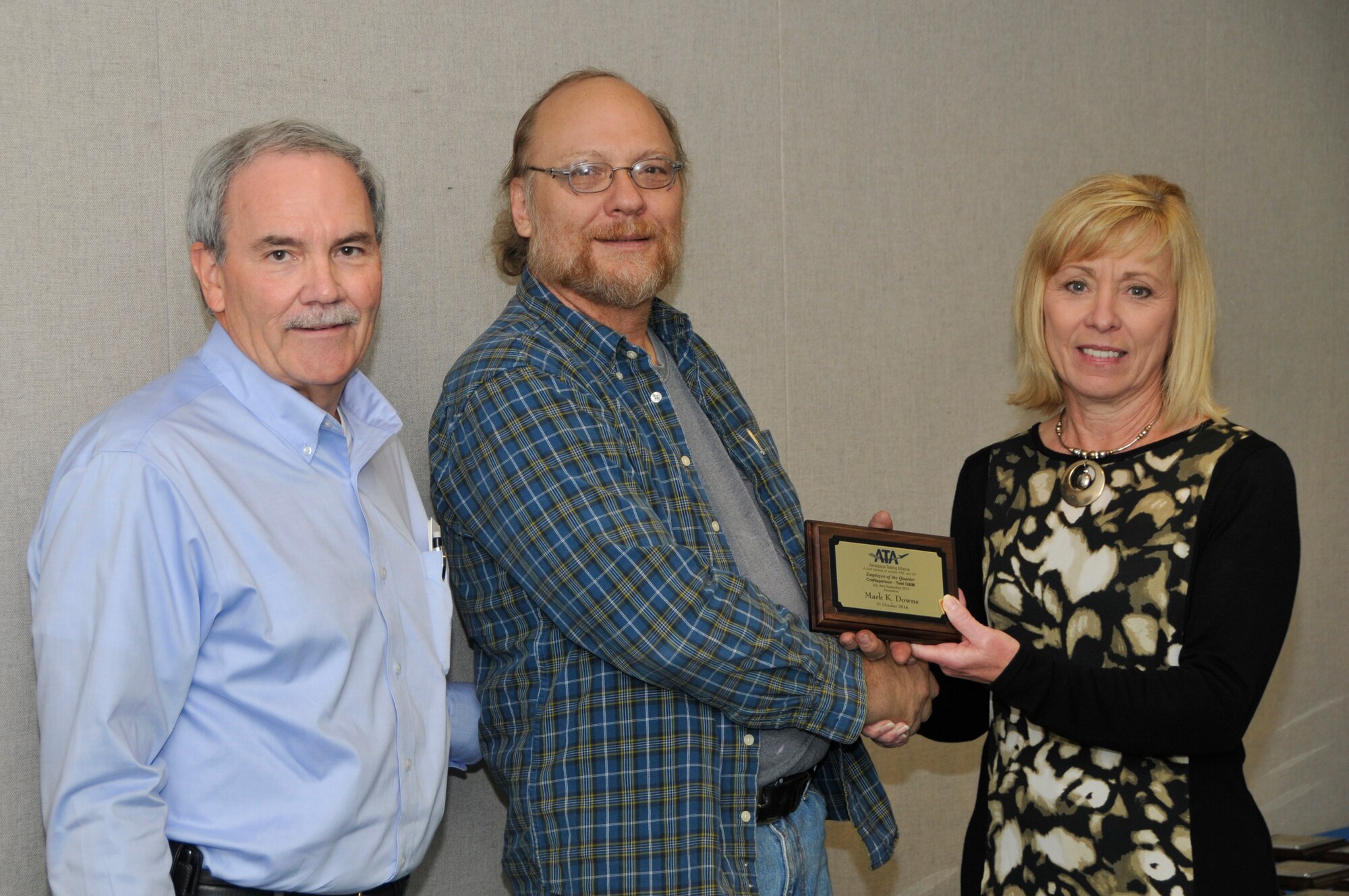 Mark Downs (center), with the ATA Integrated Test and Evaluation Department, accepts the ATA Craftsperson of the Quarter Award from Dave Simmons (left), the ATA deputy director of the Mission Support Department, and Debbie Bayer, the ATA deputy director of the Test Assets and Support Department.