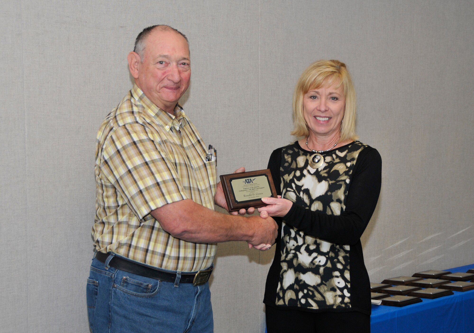 Ronald Green (left), with the ATA Test Assets and Support (AM) Department, accepts the ATA Craftsperson of the Quarter Award from Debbie Bayer, the ATA deputy director of the AM Department.