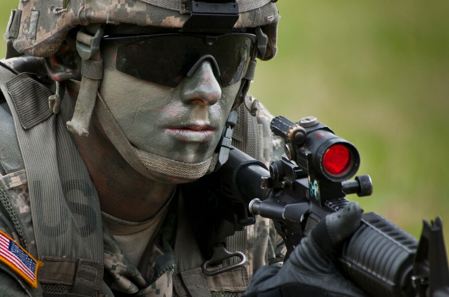 A geared-up Ranger scans the treeline during a demonstration at the 6th Ranger Training Battalion’s Open House event May 10 at Eglin Air Force Base, Fla. The event was a chance for the public to learn how Rangers train and operate. The event displays showed equipment, weapons, a reptile zoo, face painting and weapon firing among others. The demonstrations showed off hand-to-hand combat, a parachute jump, snake show, and Rangers in action. (U.S. Air Force photo/Tech. Sgt. Sam King)