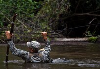 Staff Sgt. Ariel Rivera, 6th Ranger Training Battalion, crosses the river using a rope to reach a memorial on Eglin Air Force Base, Fla., for the four fallen Rangers who lost their lives Feb. 16, 1995. More than 40 Soldiers participated in the excursion Sept. 25 that followed in the footsteps of the tragic squad to learn from their experience and understand what took place that night almost 20 years ago.