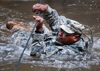 A 6th Ranger Training Battalion Soldier crosses the water using a rope to get to a memorial on Eglin Air Force Base, Fla., for the four fallen Rangers who lost their lives Feb. 16, 1995. More than 40 Soldiers participated in the excursion Sept. 25 that followed in the footsteps of the tragic squad to learn from their experience and understand what took place that night almost 20 years ago.