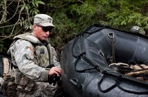 A 6th Ranger Training Battalion Soldier secures a raft prior to entering a swamp enroute to a memorial on Eglin Air Force Base, Fla., for the four fallen Rangers who lost their lives Feb. 16, 1995. More than 40 Soldiers participated in the excursion Sept. 25 that followed in the footsteps of the tragic squad to learn from their experience and understand what took place that night almost 20 years ago. 