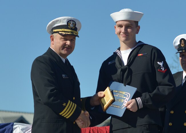 Captain Ace Van Wagoner, Commander Naval Air Forces U.S. Atlantic Fleet Force Nuclear Propulsion officer, presents Petty Officer 3rd Class Nicholas Hope a plaque in recognition of his being named the enlisted class honor graduate at the Naval Nuclear Power Training Command graduation Nov. 21, 2014, at Joint Base Charleston, S.C. Van Wagoner was the guest speaker during the ceremony. (U.S. Navy photo/Petty Officer 2nd Class Jason Pastrick)