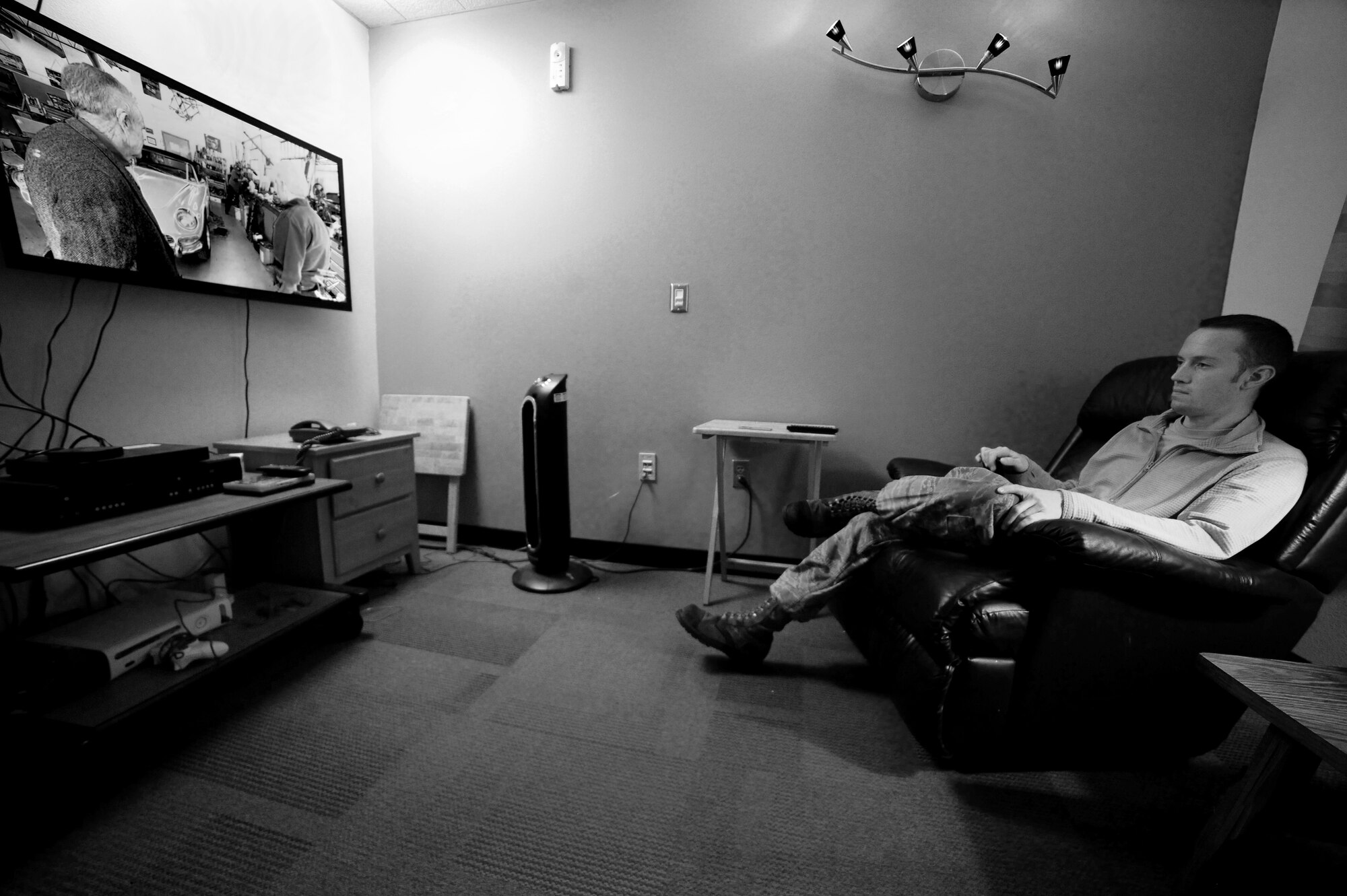 Oregon Air National Guard Staff Sgt. Sean Nye takes a short break after the morning inspections and maintenance procedures have been completed on Thanksgiving Day, Nov. 27, 2014, at the Alert Facility, Portland Air National Guard Base, Ore.  (U.S. Air National Guard photo by Tech. Sgt. John Hughel, 142nd Fighter Wing Public Affairs/Released)